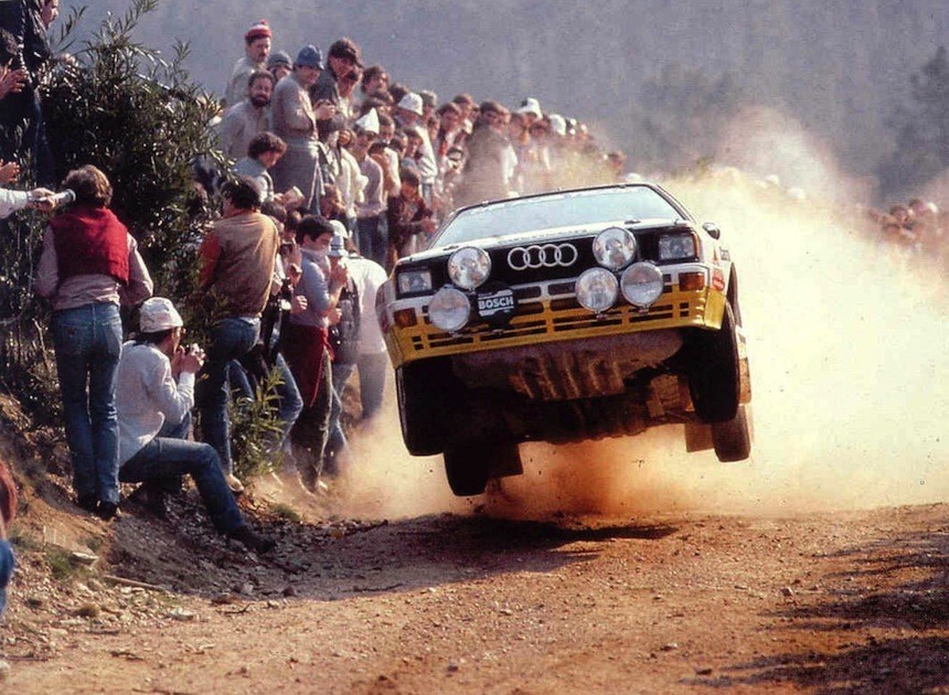 The fire-spitting Audi Quattro S1 airborne, flying inches past spectators in the craziest era of rallying