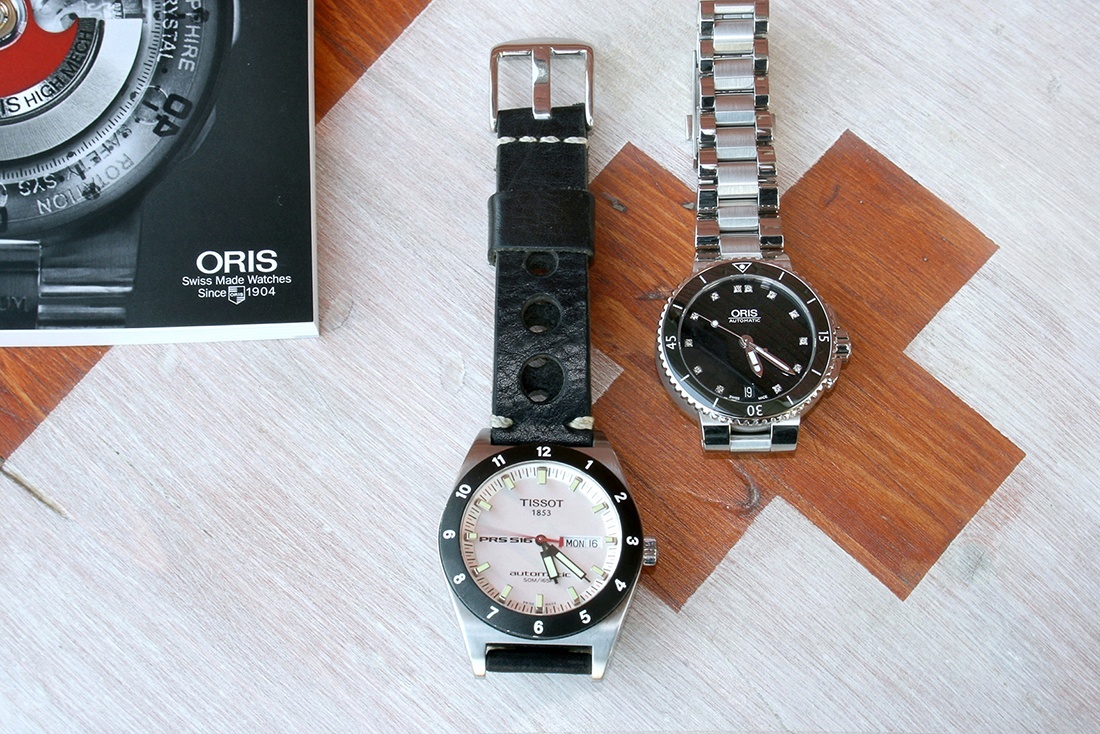 My daughter's future ORIS Aquis Diamond Date next to my very first mechanical watch: An automatic Tissot PRS-516.