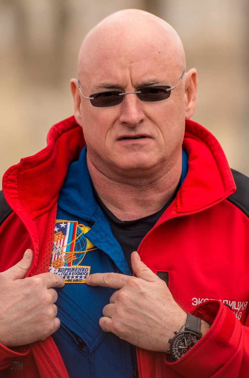 Expedition 43 NASA Astronaut Scott Kelly describes his One-Year mission patch to members of the press during media day, Saturday, March 21, 2015, at the Cosmonaut Hotel in Baikonur, Kazakhstan. Kelly, and Russian Cosmonauts Mikhail Kornienko, and Gennady Padalka of the Russian Federal Space Agency (Roscosmos) are scheduled to launch to the International Space Station in the Soyuz TMA-16M spacecraft from the Baikonur Cosmodrome in Kazakhstan March 28, Kazakh time (March 27 Eastern time). As the one-year crew, Kelly and Kornienko will return to Earth on Soyuz TMA-18M in March 2016. Photo Credit: (NASA/Bill Ingalls)