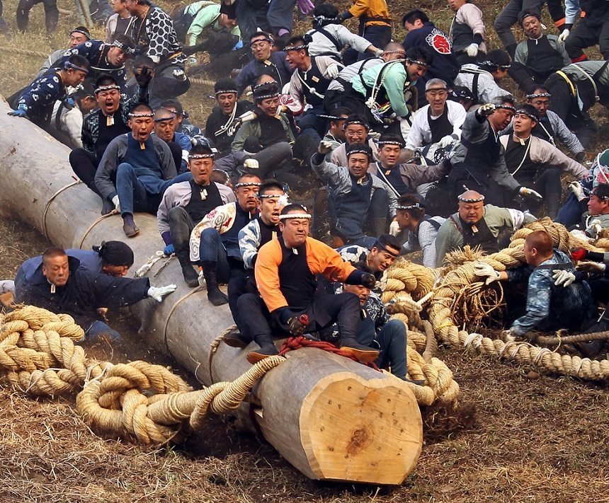 SHIMOSUWA, JAPAN - APRIL 09: Participants astride a huge log slide down a hill during the Onbashira Festival on April 9, 2010 in Shimosuwa, Japan. The septennial festival has taken place for the past 1,200 years. The huge timbers are used as sacred pillars for the Suwa Grand Shrines of Kamisha and Shimosha, which are re-built in Suwa City. The lumbers' journey down the mountainside often results in injury and fatalities as participants try to ride the timbers as they slide down the mountain. (Photo by Koichi Kamoshida/Getty Images)