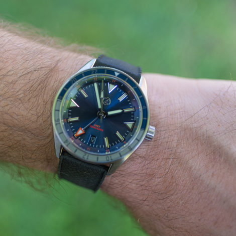 Zelos Horizon GMT on wrist over grass
